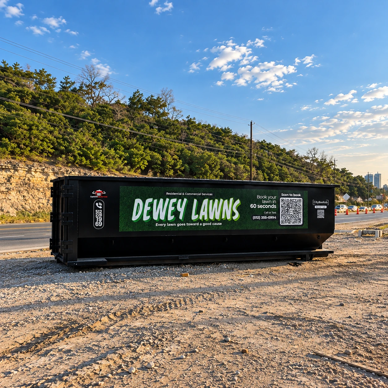 Dewey Lawns advertising container beside a road and wooded hillside
